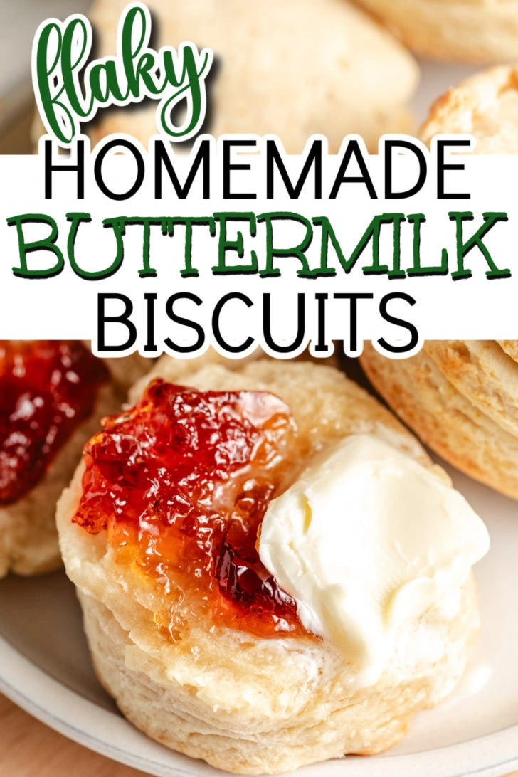 Close up view of a buttermilk biscuit with jam and butter and a plate.