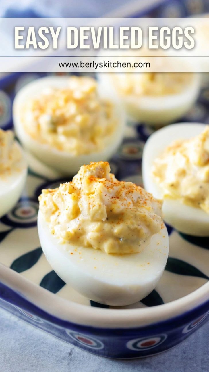 Close up view of deviled eggs on a blue and white peacock platter.