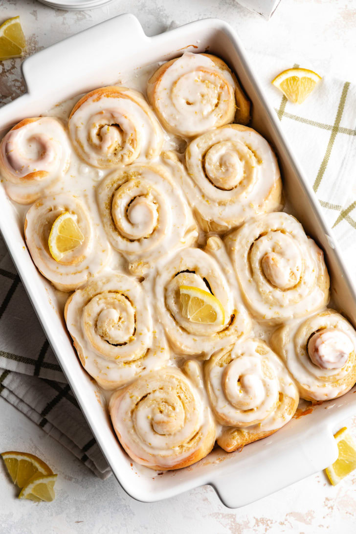 Glazed rolls in a white casserole dish.