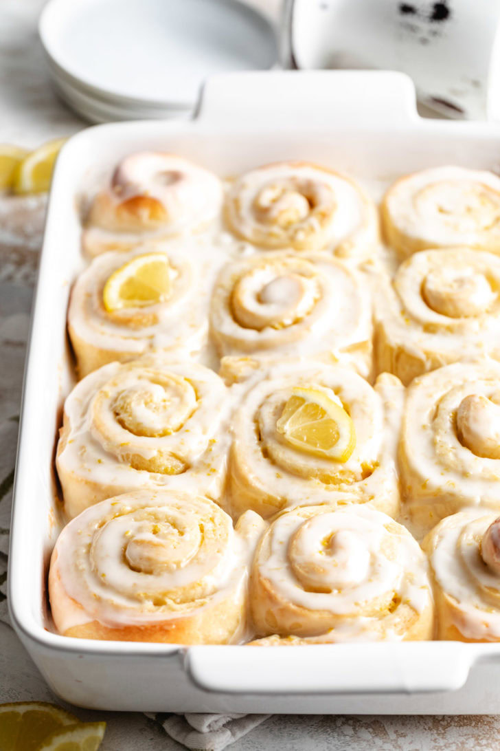 Frosted lemon sweet rolls in pan.