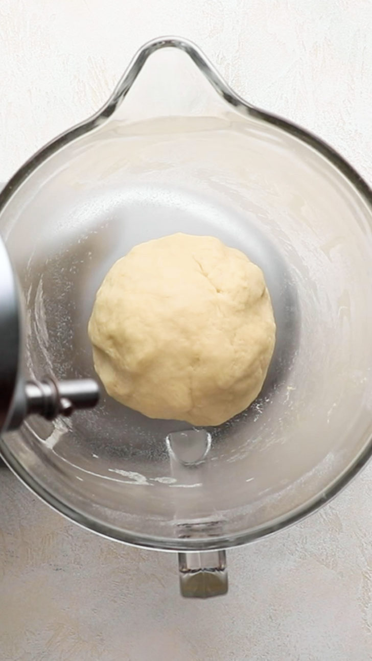 Smooth dough ball in mixer bowl.