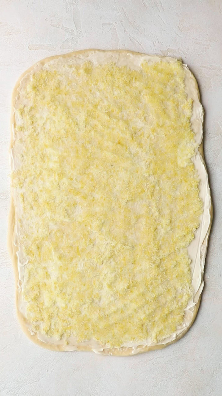 Lemon filling over rolled dough.