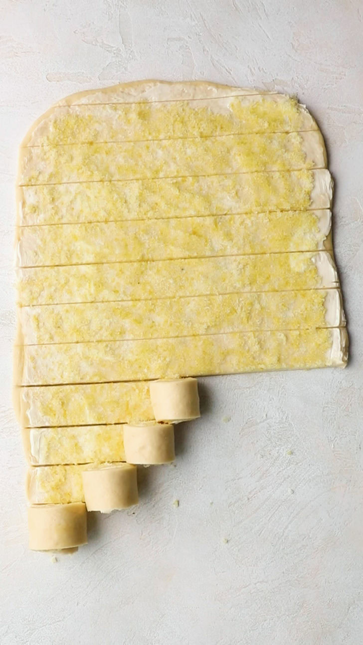 Rolled sweet dough strips on work surface.