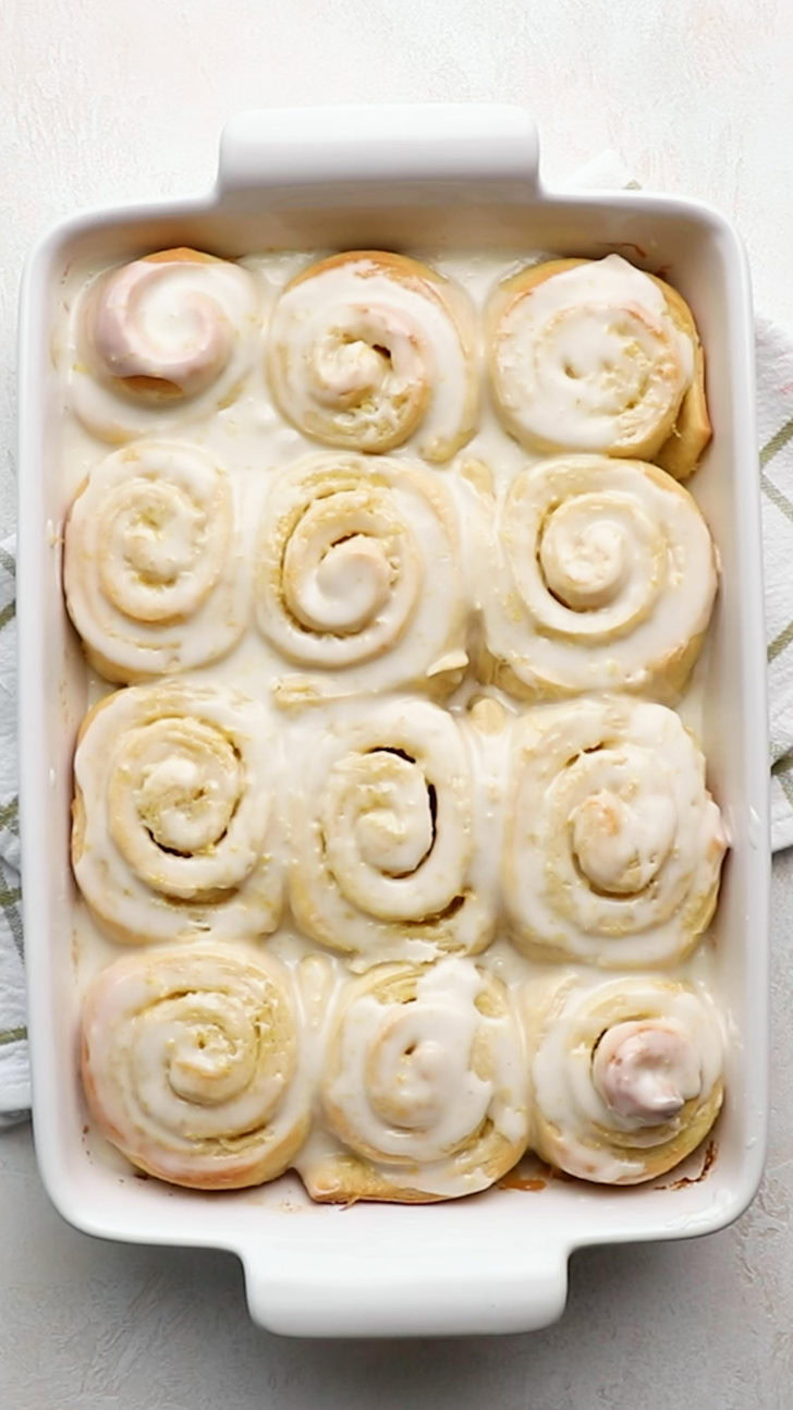 Glazed sweet rolls in white baking dish.