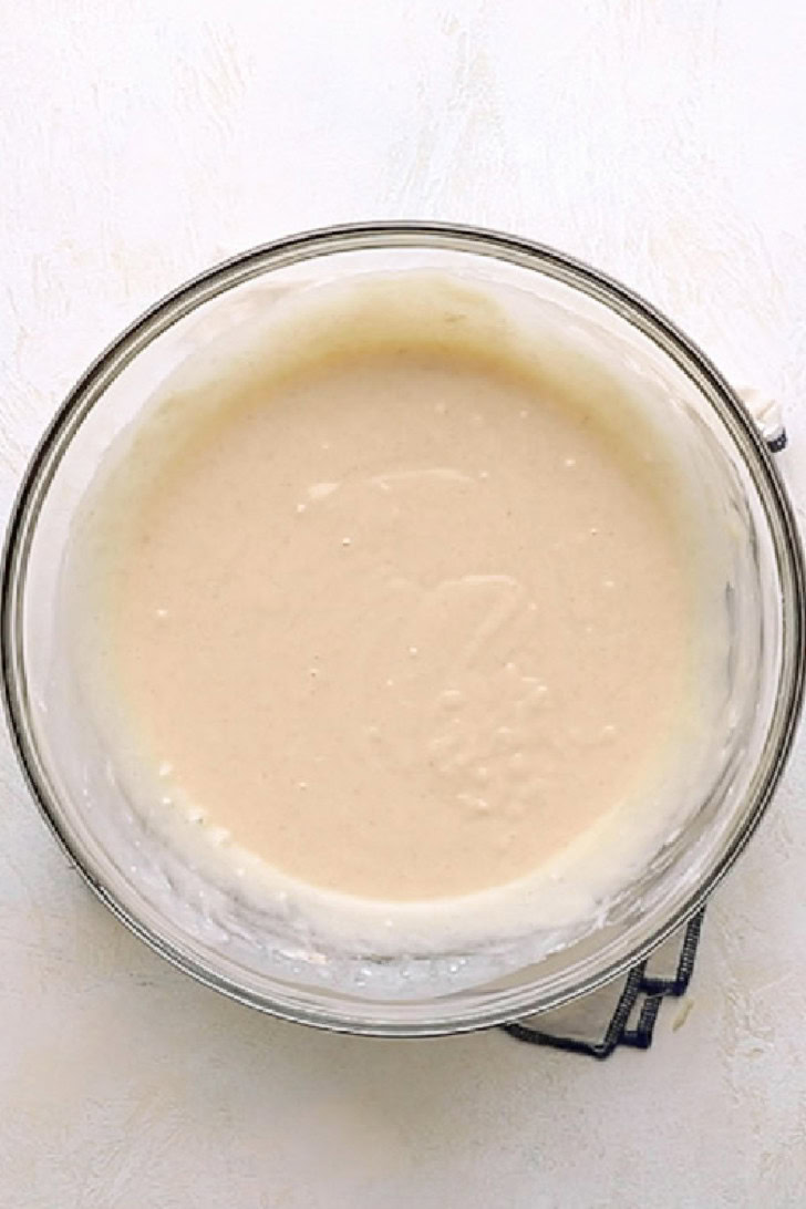 Smooth cobbler batter mixed in a glass bowl.