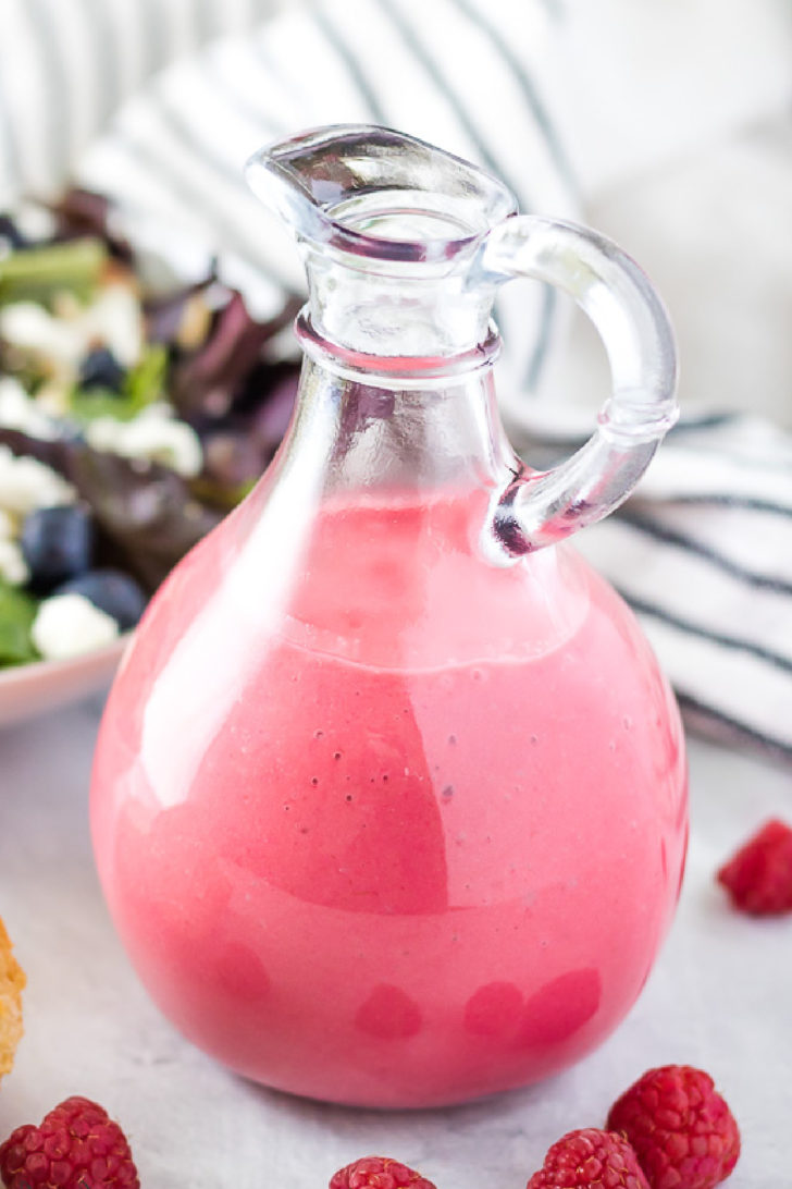 Close up view of raspberry vinaigrette in a jar.