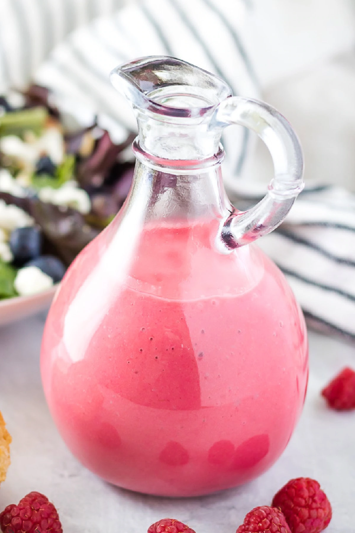 Close up view of raspberry vinaigrette in a jar.