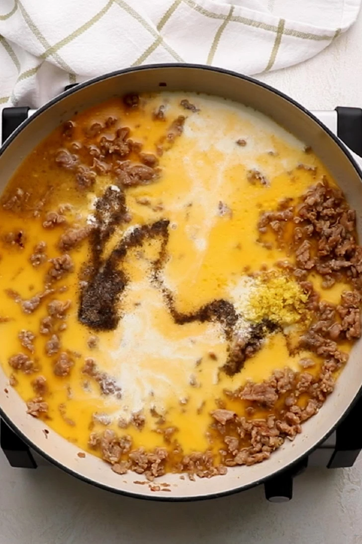 Seasonings added to creamy sausage sauce.