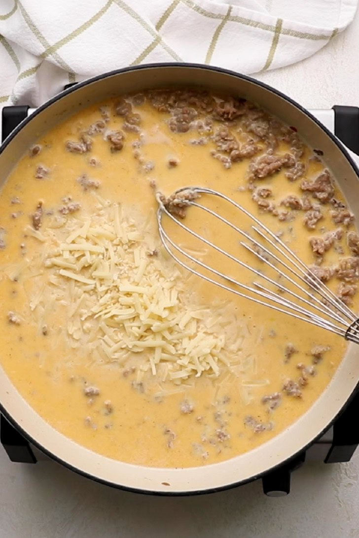 Parmesan cheese stirred into creamy sausage sauce.