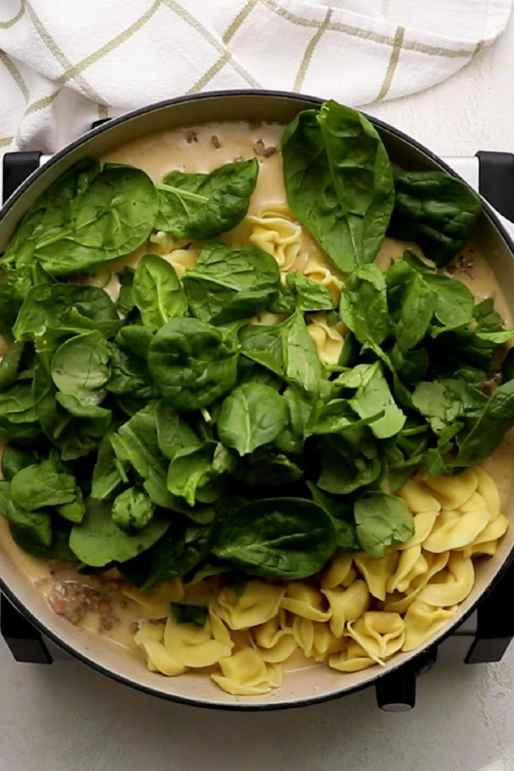 Tortellini and spinach added to lemon cream sauce.