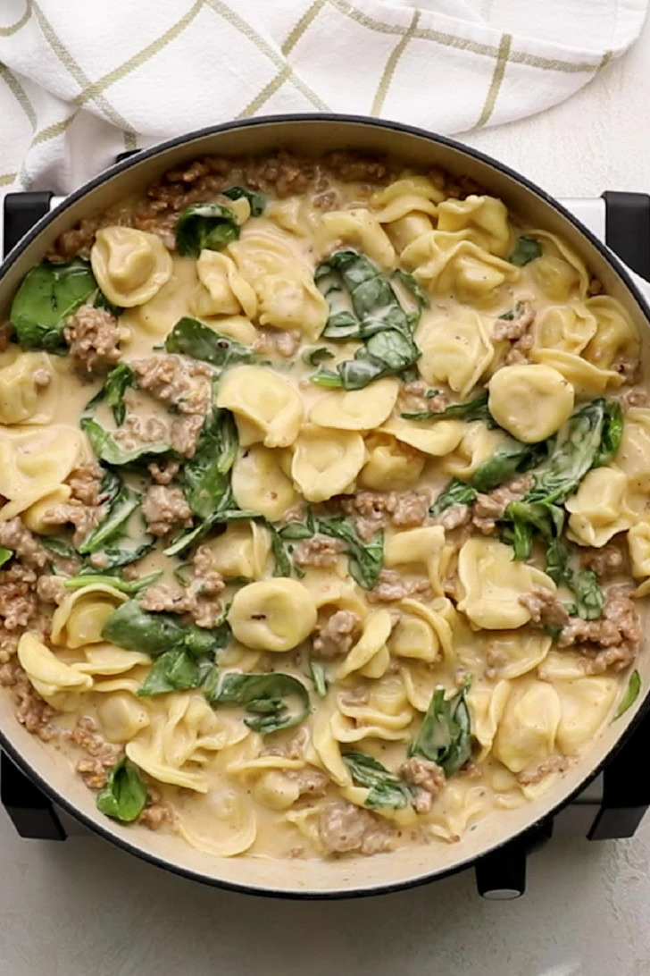 Creamy tortellini with sausage and spinach.