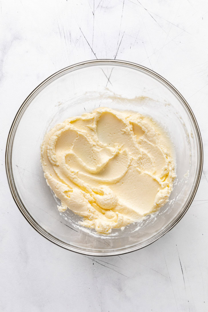 Sweetened mascarpone mixture in a glass bowl.