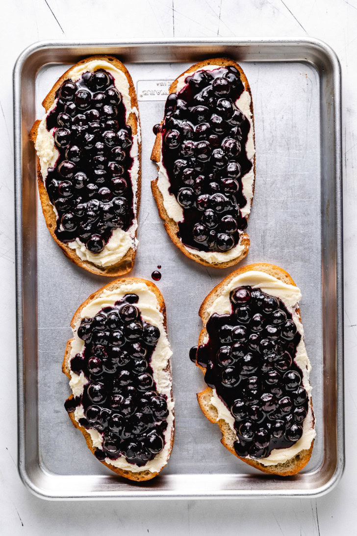 Blueberry topping spooned over mascarpone toast.