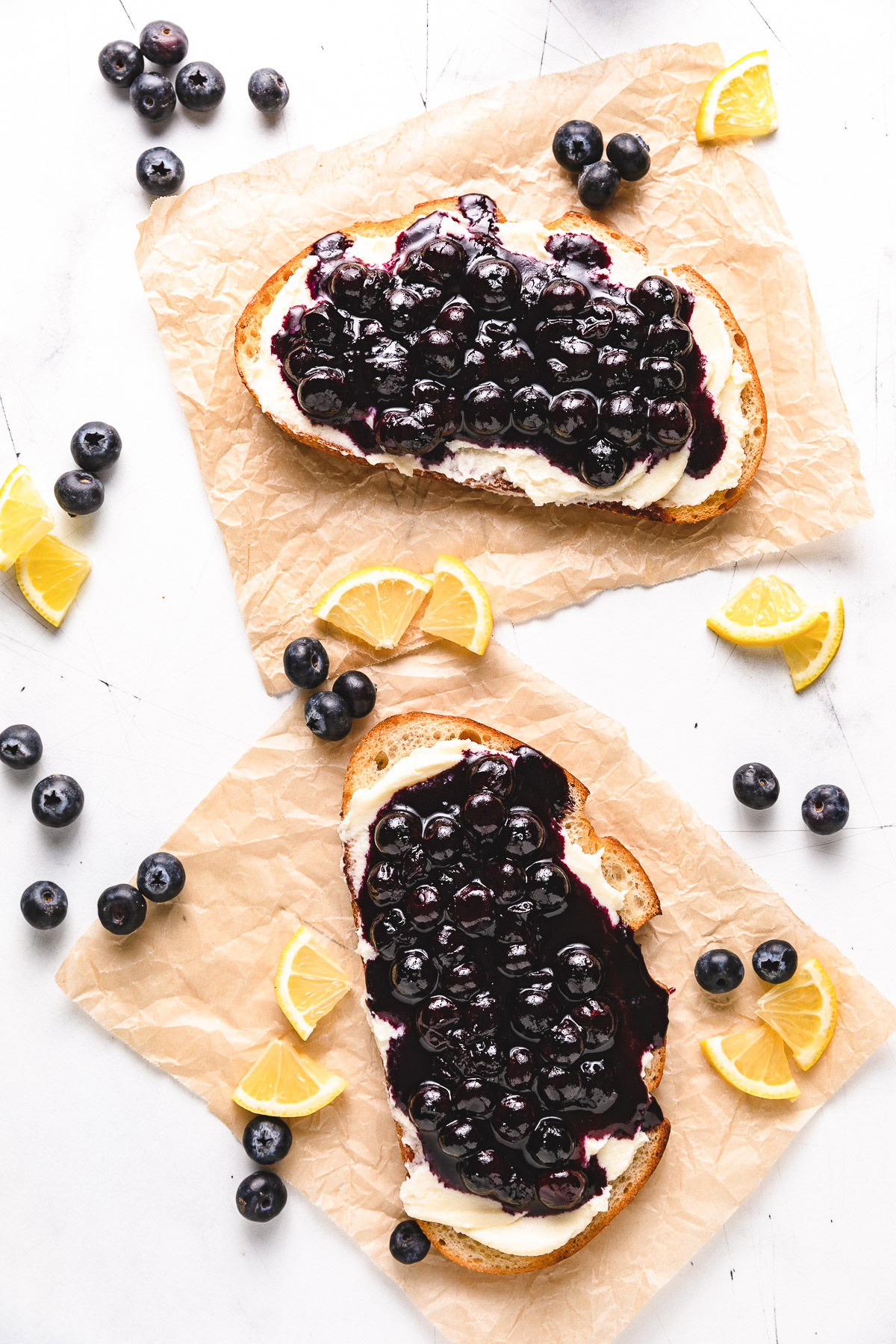 Blueberry toast with lemon wedges and fresh blueberries.