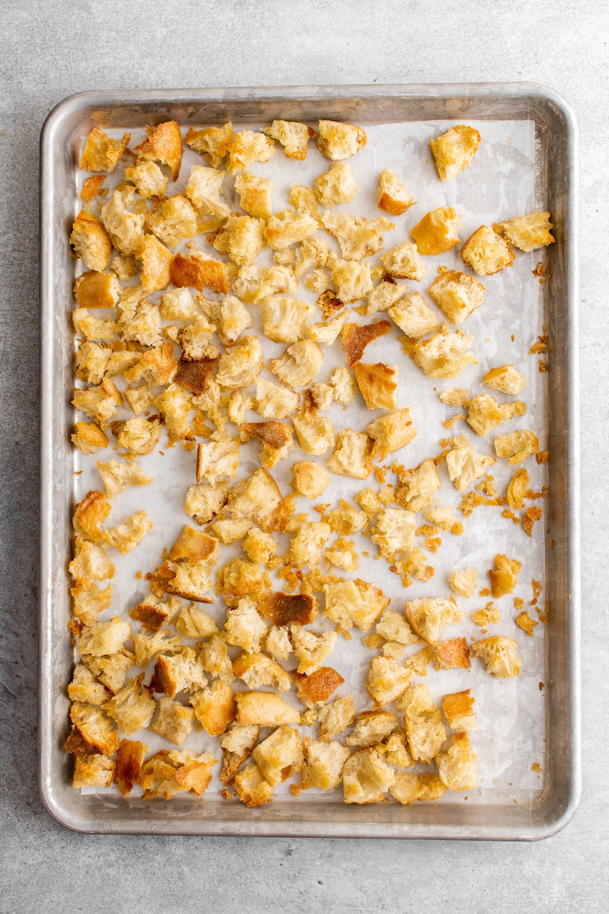 Homemade croutons on a baking sheet.