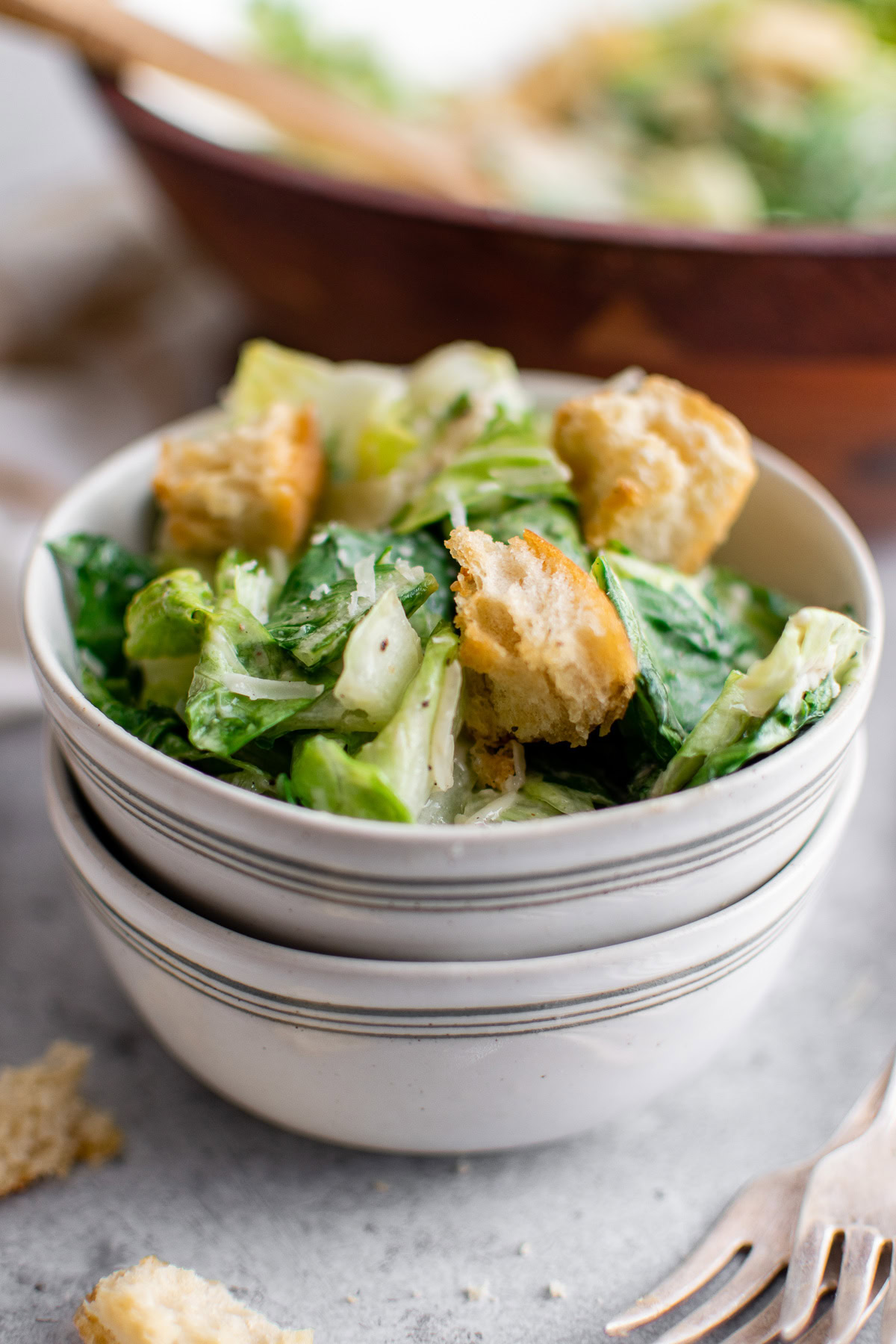 Caesar salad served in stacked bowls.
