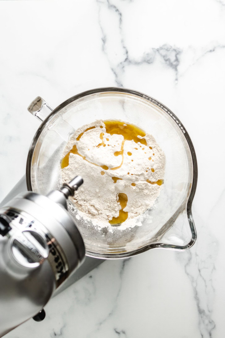 Flour and oil in a stand mixer bowl.