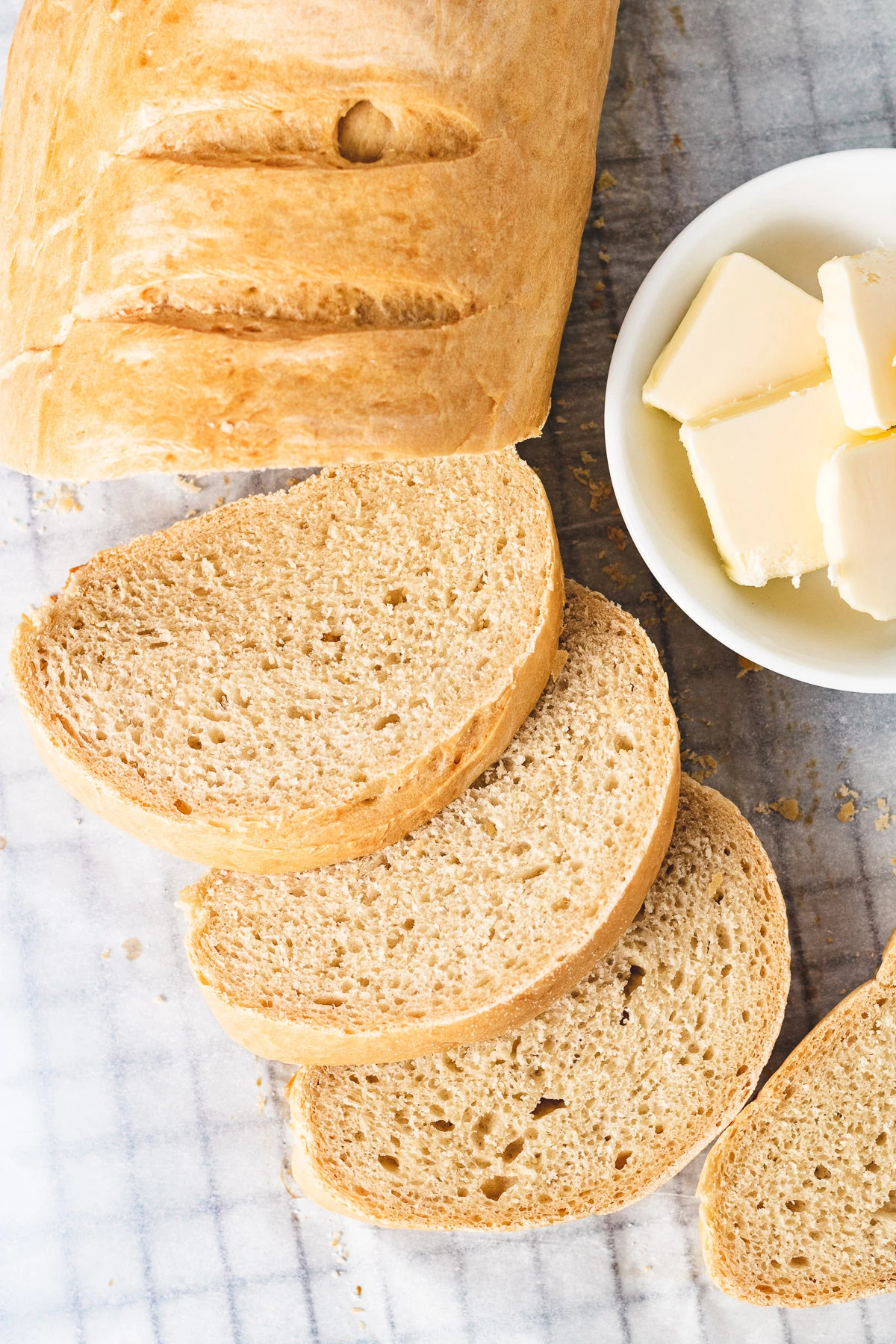 Close-up of sliced French bread and butter.