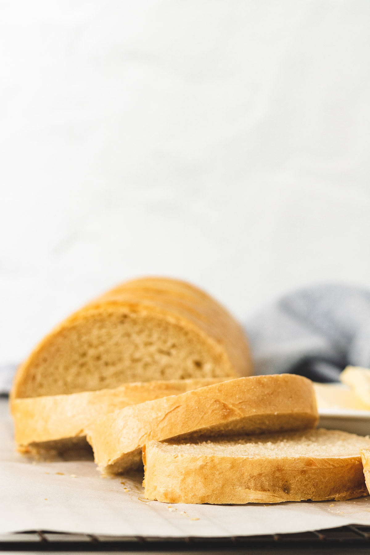 Sliced French bread on parchment paper.