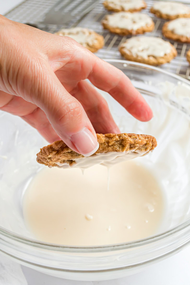 An oatmeal cookie dipped upside down into vanilla icing.