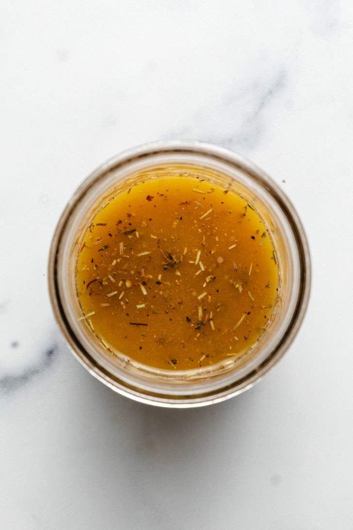 Mixed Italian dressing in a glass jar.