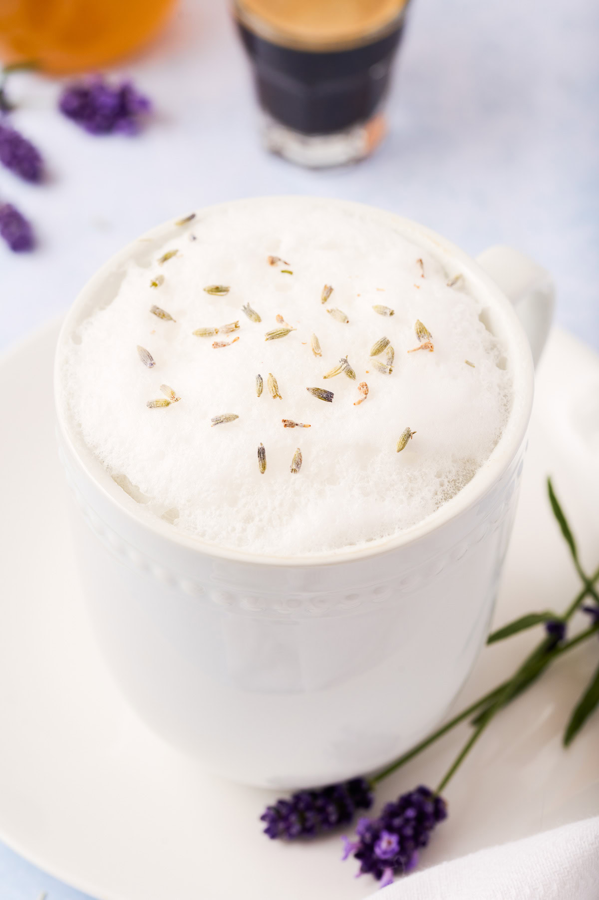 Close-up of lavender latte foam topped with dried lavender.
