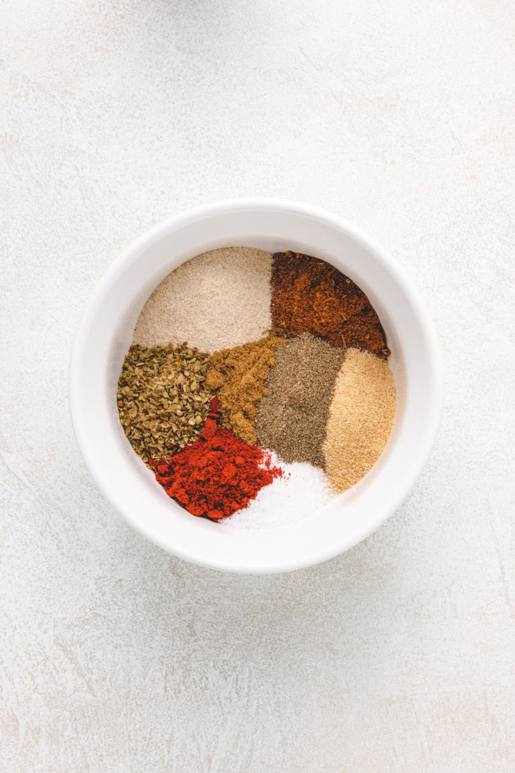 Overhead view of different spices in a bowl.