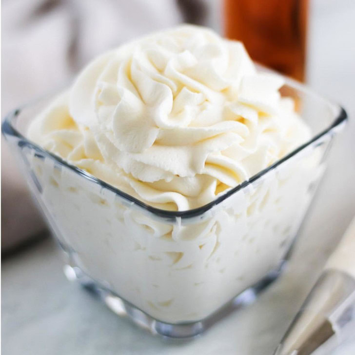 Amaretto whipped cream in a glass dish.