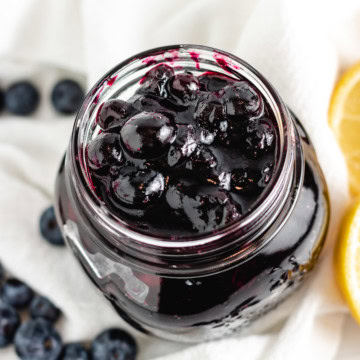 Close up overhead view of blueberry compote in a jar.
