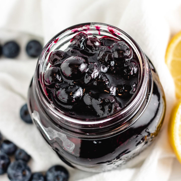 Close up overhead view of blueberry compote in a jar.