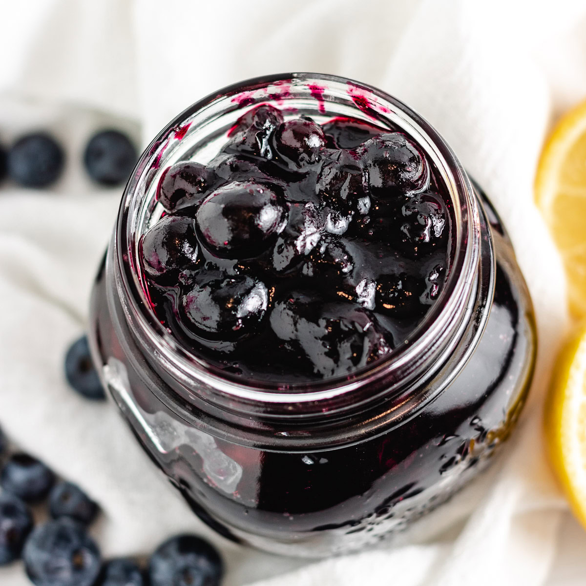 Close up overhead view of blueberry compote in a jar.
