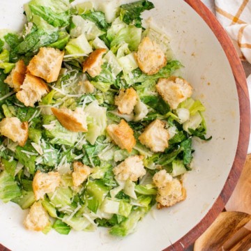 Caesar salad with croutons and Parmesan in a serving bowl.
