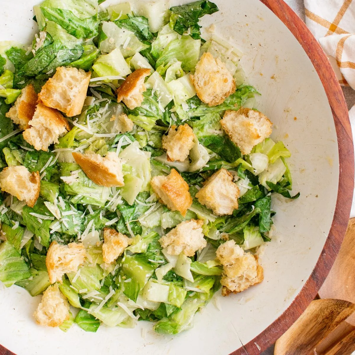Caesar salad with croutons and Parmesan in a serving bowl.
