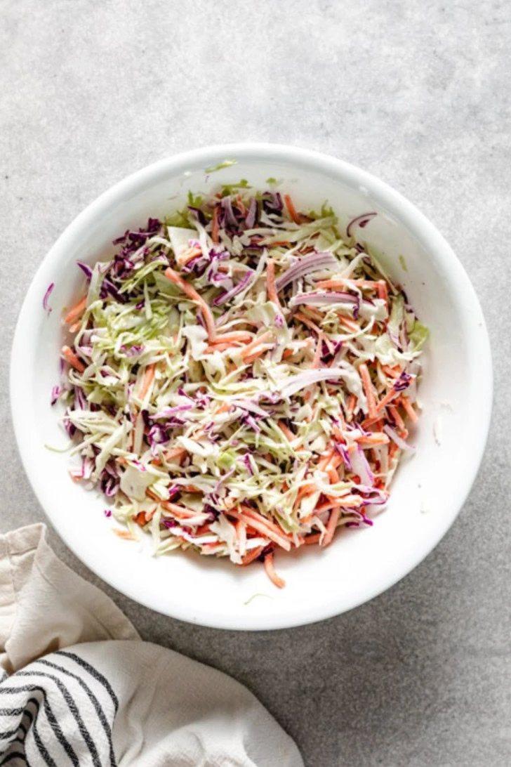 Cabbage, carrots, and onions mixed with coleslaw dressing.