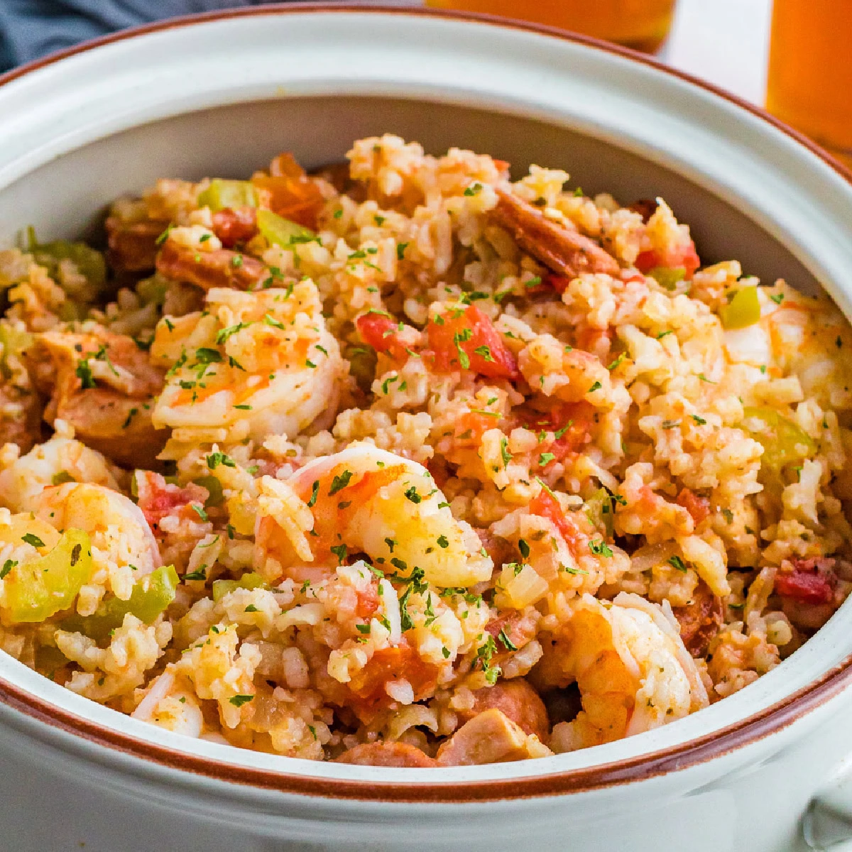 Close up view of crockpot jambalaya in a gray bowl.