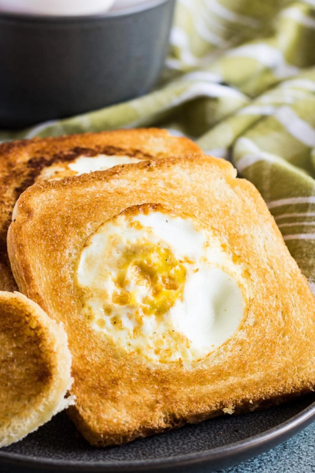 Close up view of eggs in a basket on a gray plate.