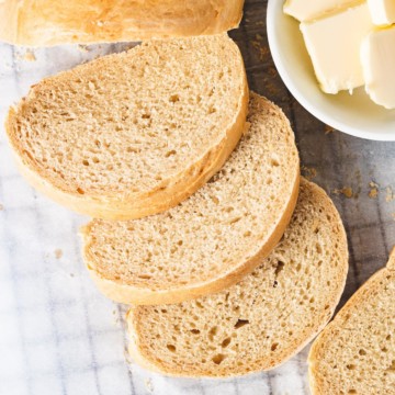 Close-up of sliced French bread with butter.