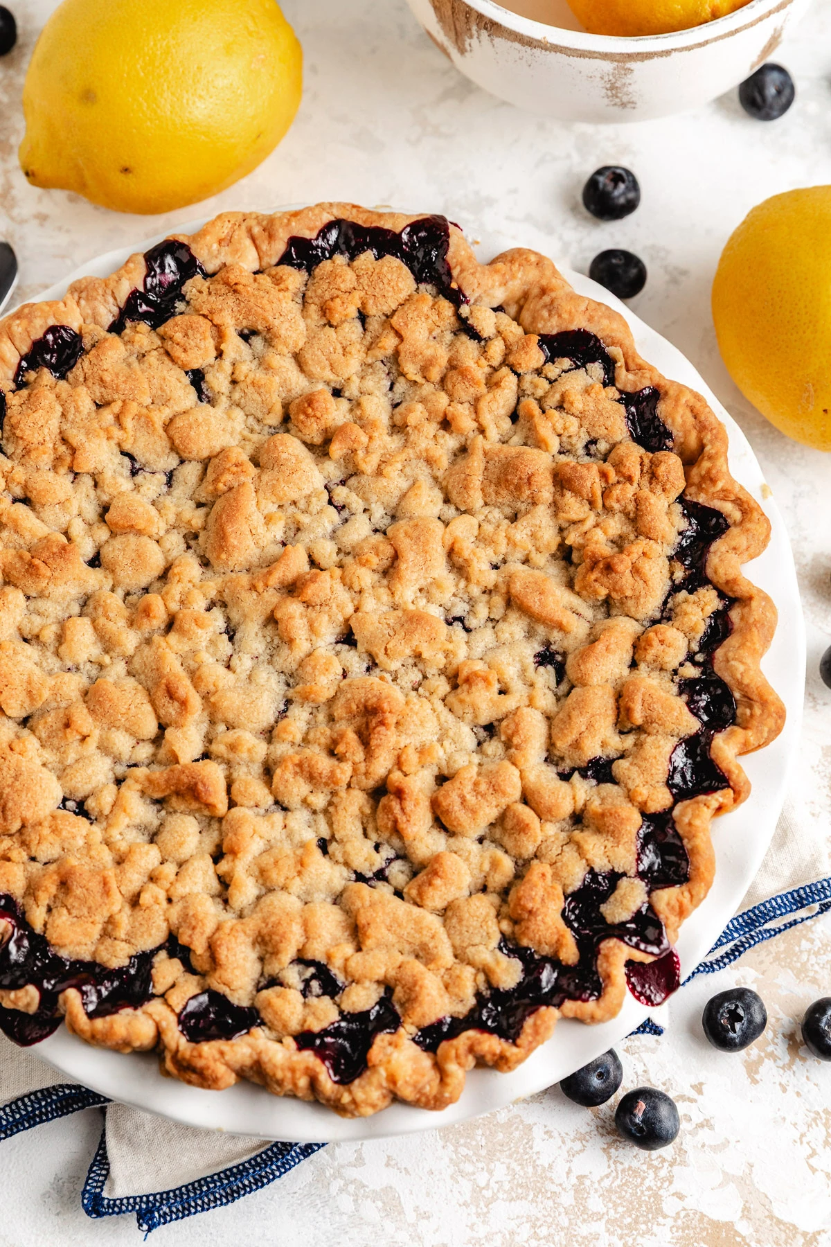 Baked lemon blueberry crumb pie with golden topping.