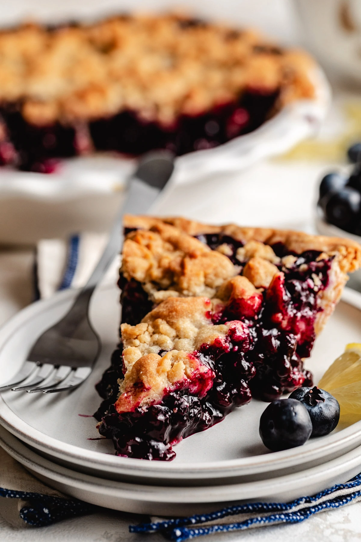 Lemon blueberry pie slice with a fork.