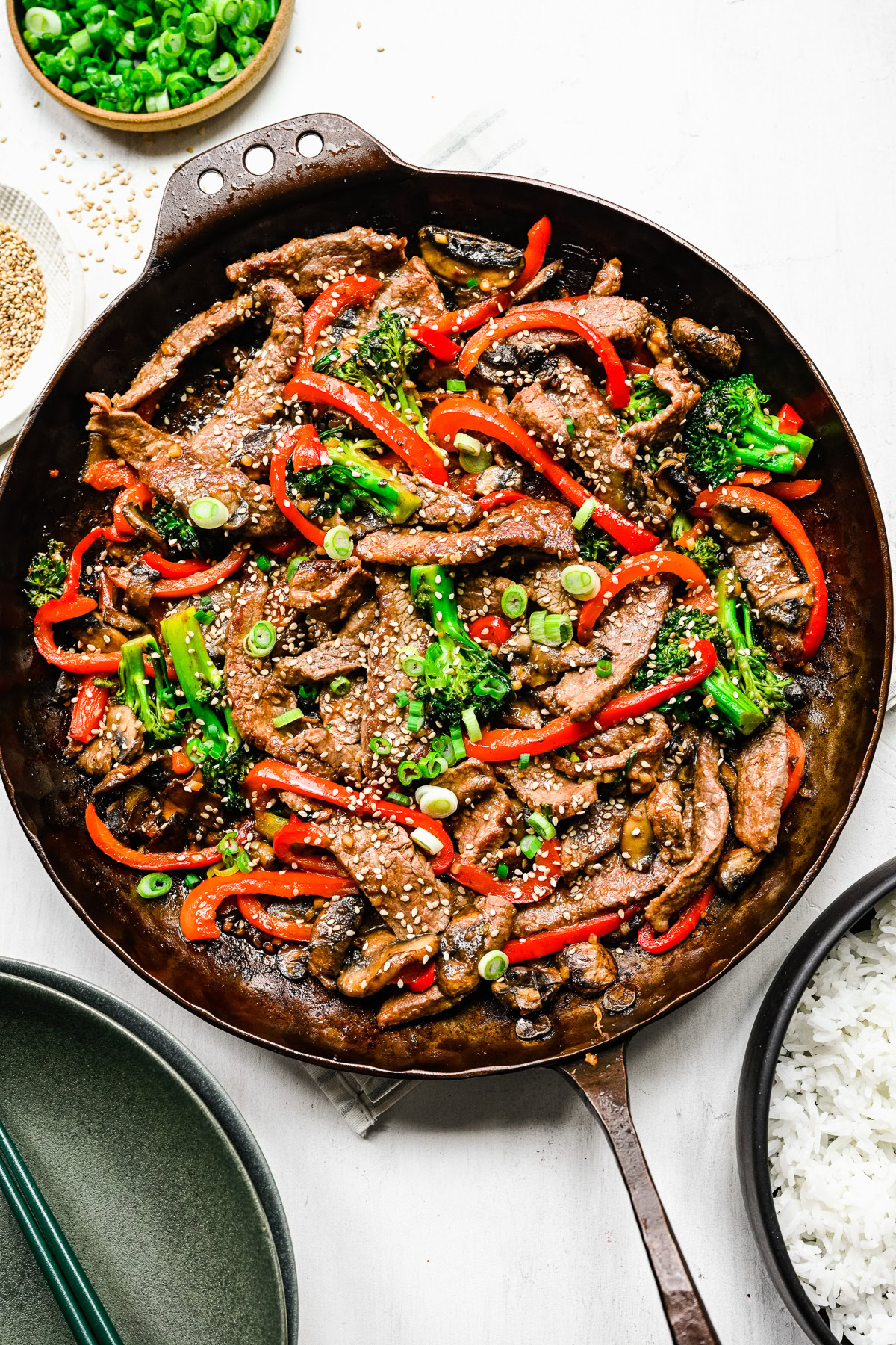 Overhead view of beef, vegetables, and white rice in a serving bowl.