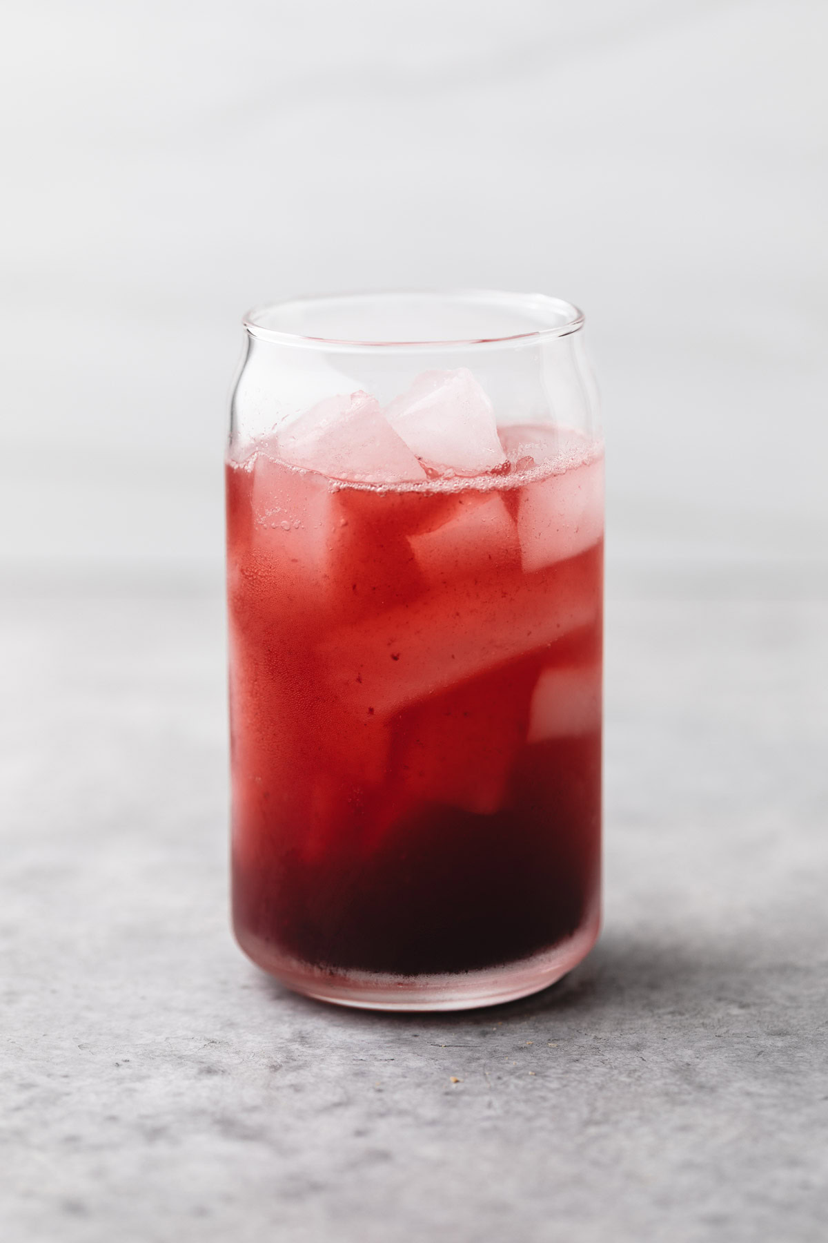 Berry mocktail poured over ice.