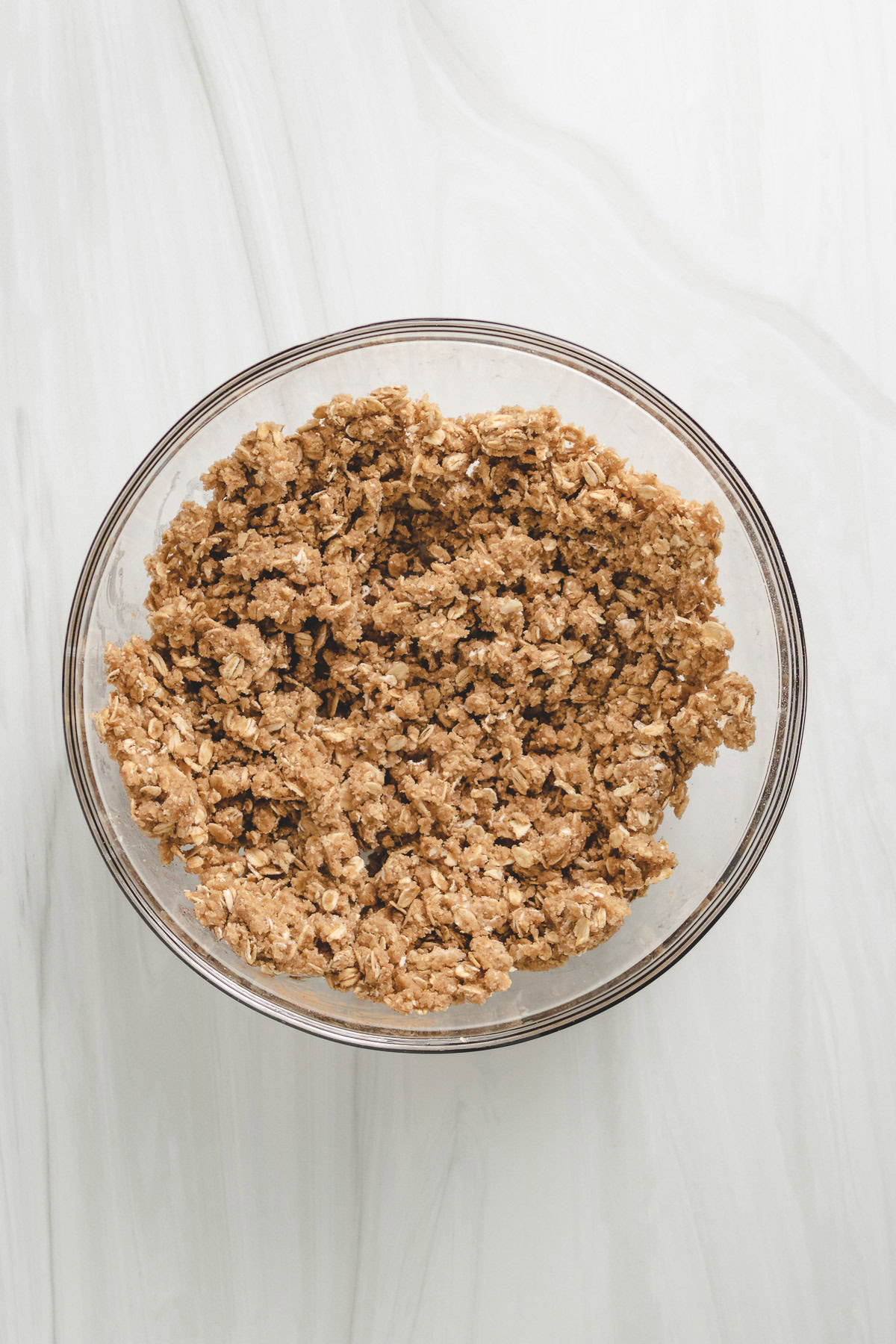 Oat crumble topping in a glass bowl.