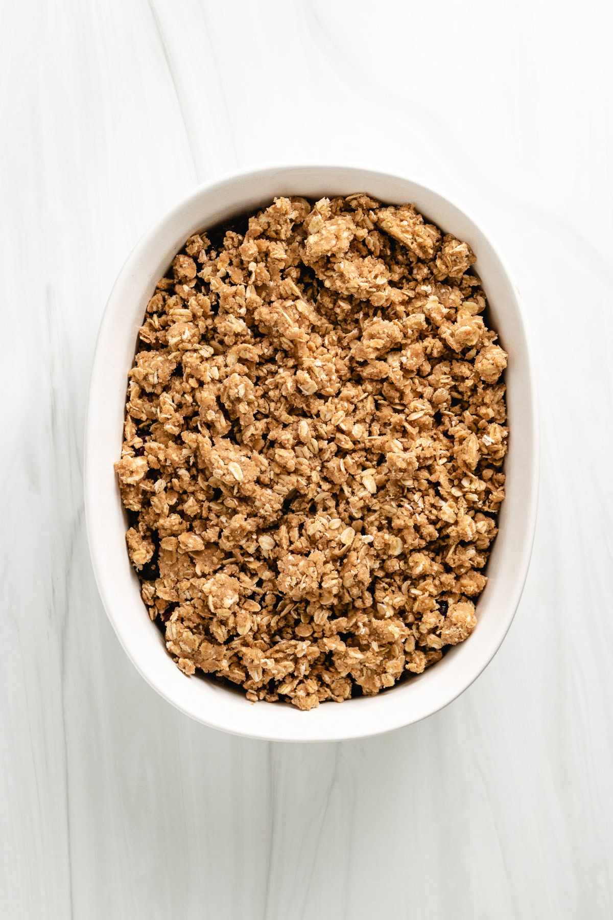 Oat topping sprinkled over cherry filling.