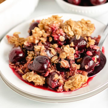 Close up view of crunchy oatmeal topping on cherry crisp.