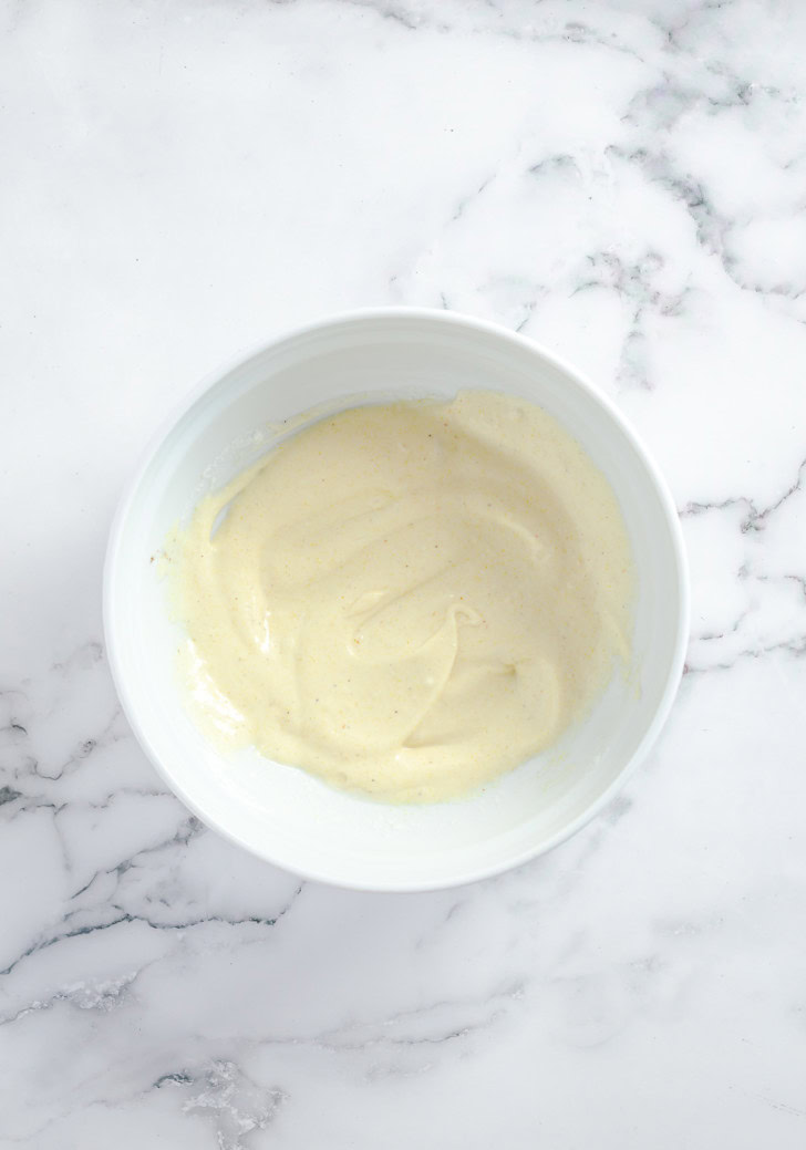 Creamy dressing mixed together in a white bowl.