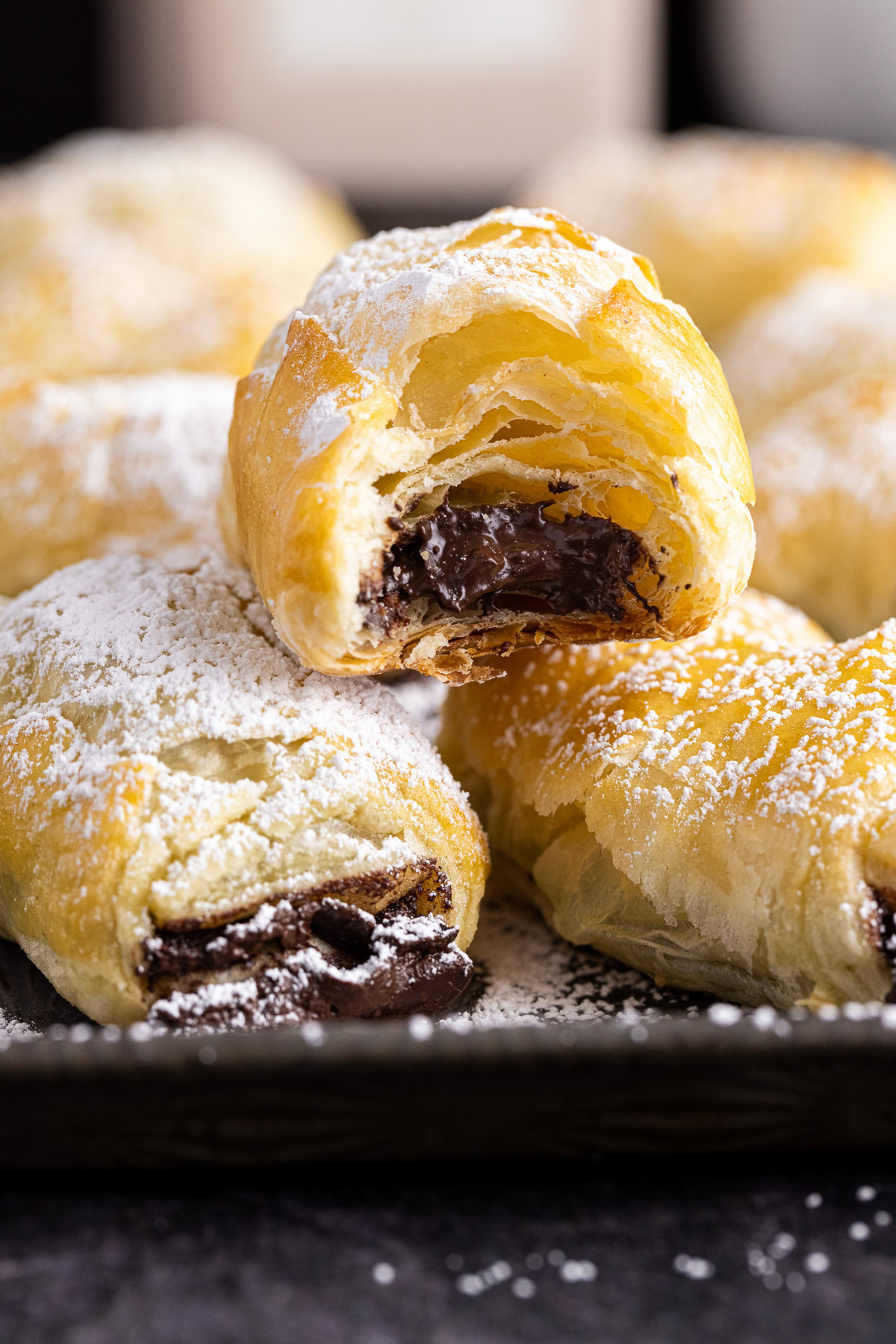 Chocolate-filled puff pastries dusted with powdered sugar.