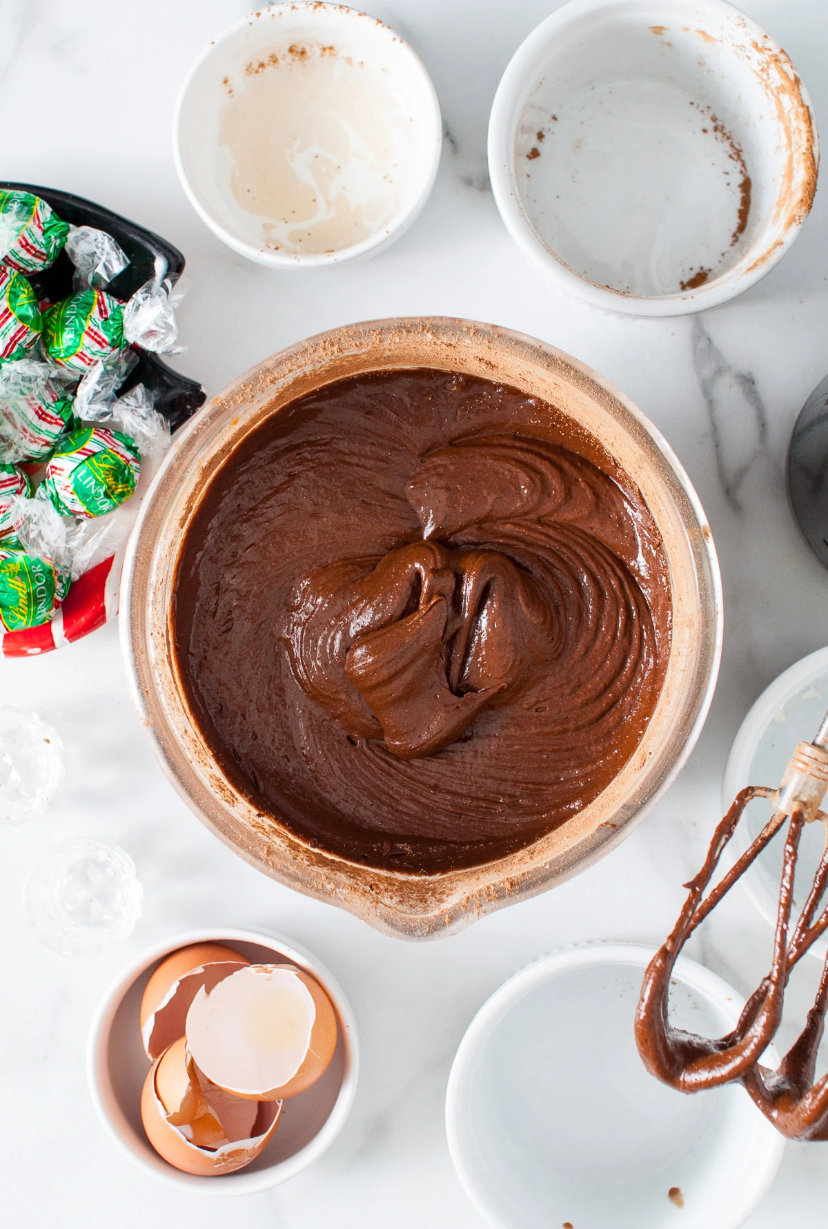 Thick chocolate brownie batter in a mixing bowl.