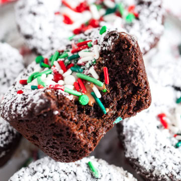 Christmas brownies filled with melted chocolate and topped with powdered sugar and Christmas sprinkles.