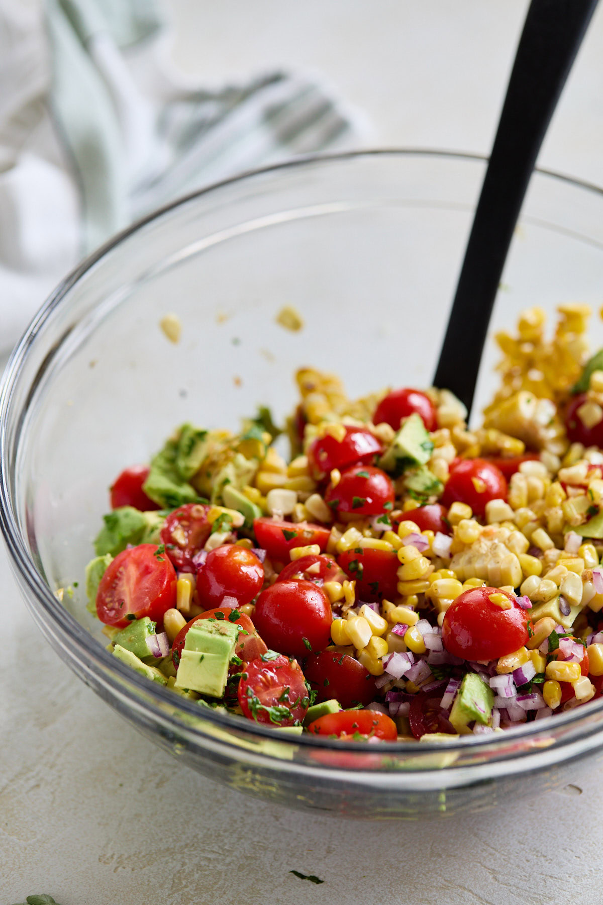 Corn, avocado, tomato, and onion tossed in lime dressing.