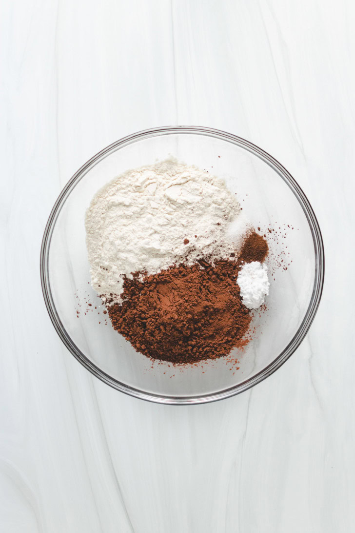 Dry ingredients for chocolate cookies in a glass bowl.